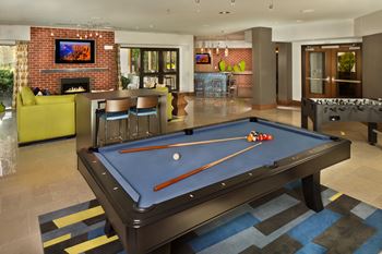 Game room with shuffleboard, foosball, billiards and poker table